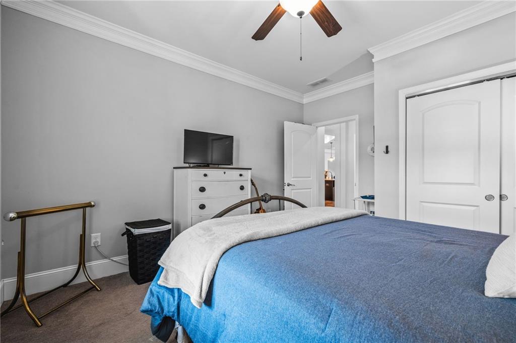 4883 Pleasantry Way Northwest Acworth, GA 30101 - Photo 25 of 46 a bedroom with a bed and a flat tv screen on dresser