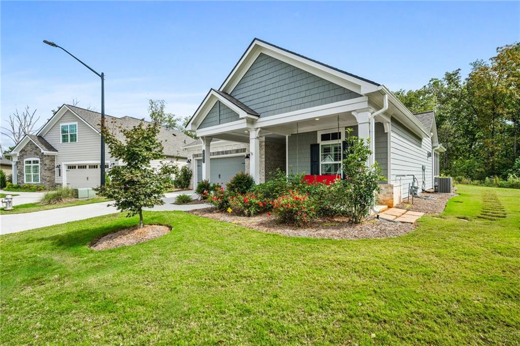 4883 Pleasantry Way Northwest Acworth, GA 30101 - Photo 3 of 46 a view of a house with a big yard potted plants and a large tree