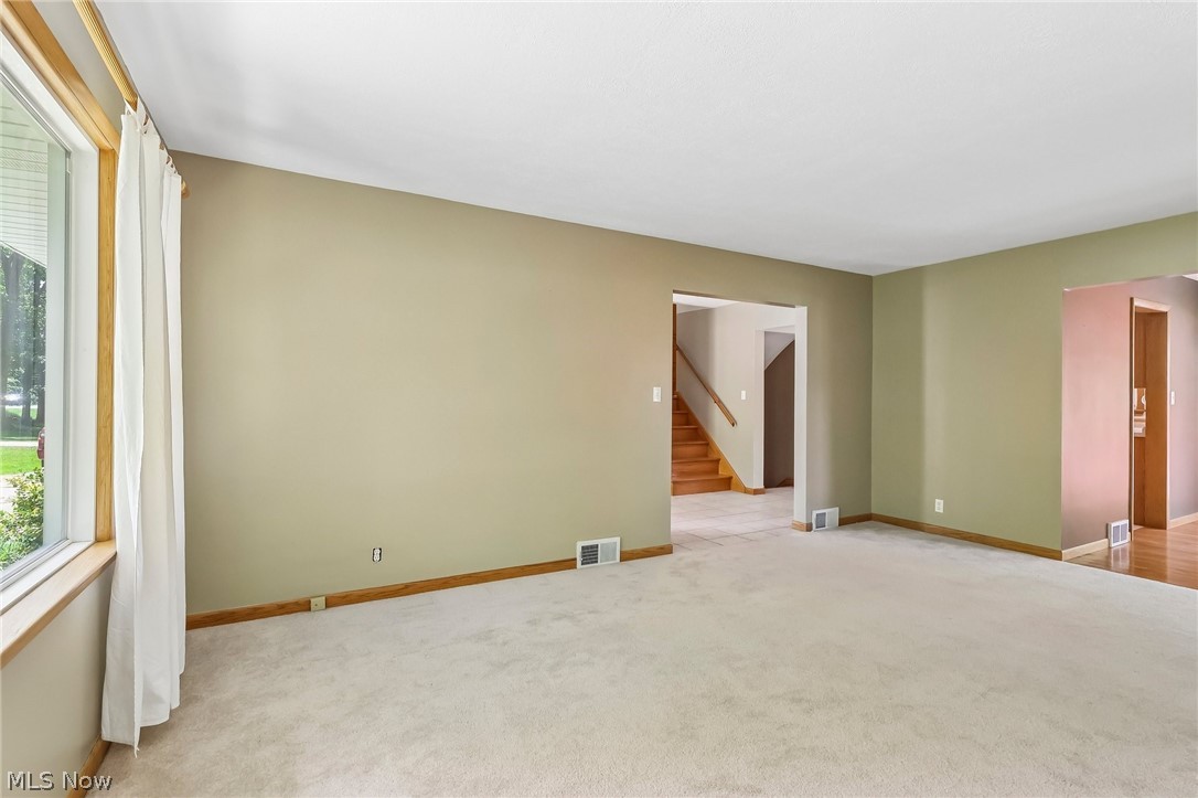 1638 South Cleveland Massillon Road Akron, OH 44321 - Photo 15 of 37 Carpeted living area with neutral wall tones and wood trim