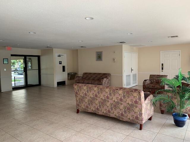 4154 Inverrary Drive, Unit 407 Lauderhill, FL 33319 - Photo 38 of 39 a living room with furniture and potted plants