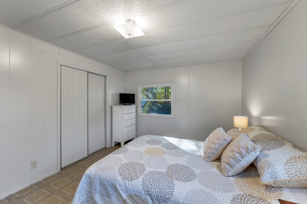 28 Brooks Road, Unit 28 Seabrook, NH 03874 - Photo 13 of 34 a bedroom with a bed and a window