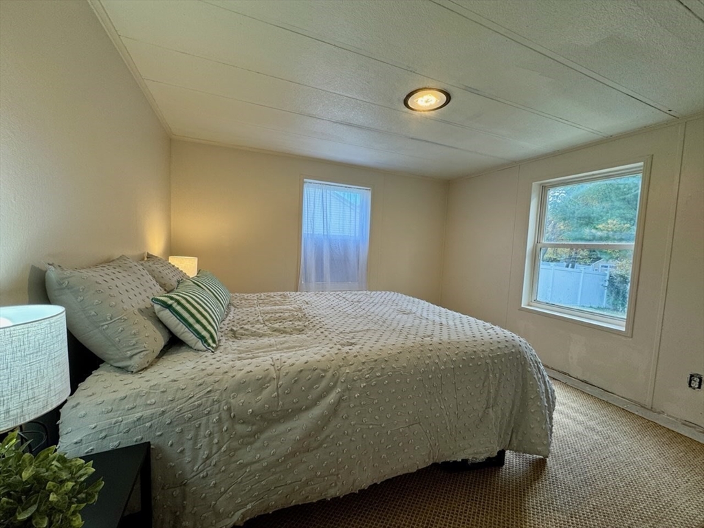 28 Brooks Road, Unit 28 Seabrook, NH 03874 - Photo 20 of 34 a bedroom with a bed and a window