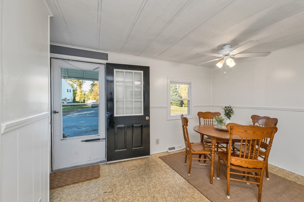 28 Brooks Road, Unit 28 Seabrook, NH 03874 - Photo 7 of 34 a view of a dining room with furniture and a window