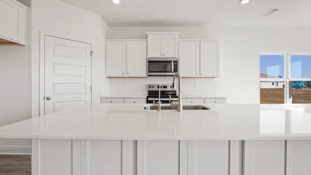 a kitchen with a sink and chandelier