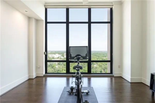 an empty room with wooden floor windows and view