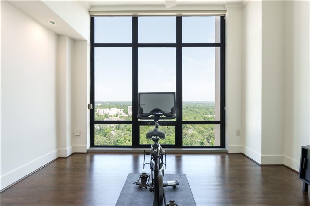 3475 Oak Valley Road Northeast, Unit 2940 Atlanta, GA 30326 - Photo 12 of 26 an empty room with wooden floor windows and view