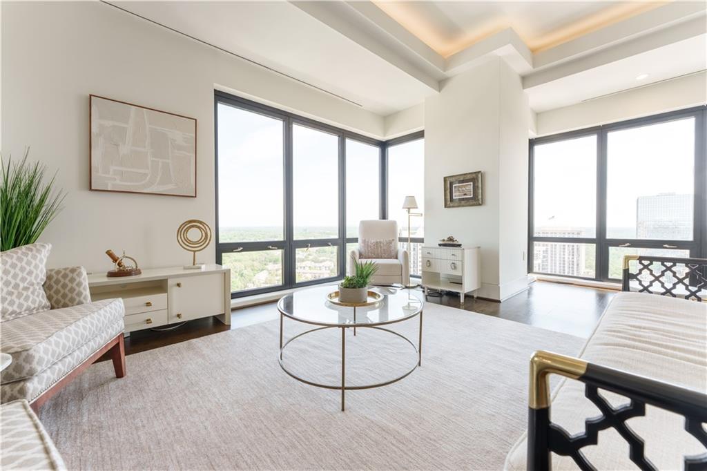 3475 Oak Valley Road Northeast, Unit 2940 Atlanta, GA 30326 - Photo 16 of 26 a living room with furniture a rug potted plant and a large window