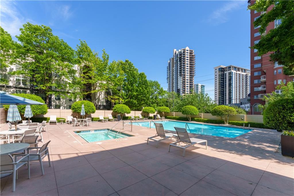 3475 Oak Valley Road Northeast, Unit 2940 Atlanta, GA 30326 - Photo 21 of 26 a wooden bench sitting in front of a building