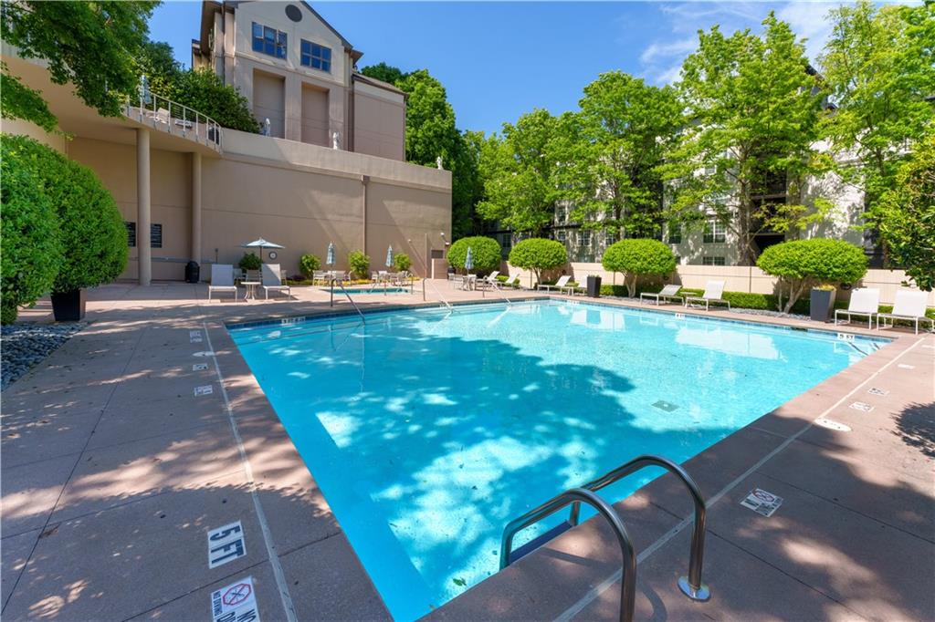 3475 Oak Valley Road Northeast, Unit 2940 Atlanta, GA 30326 - Photo 22 of 26 a view of a swimming pool with a patio