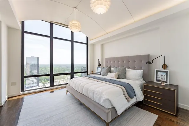 a bedroom with a large bed and a large window