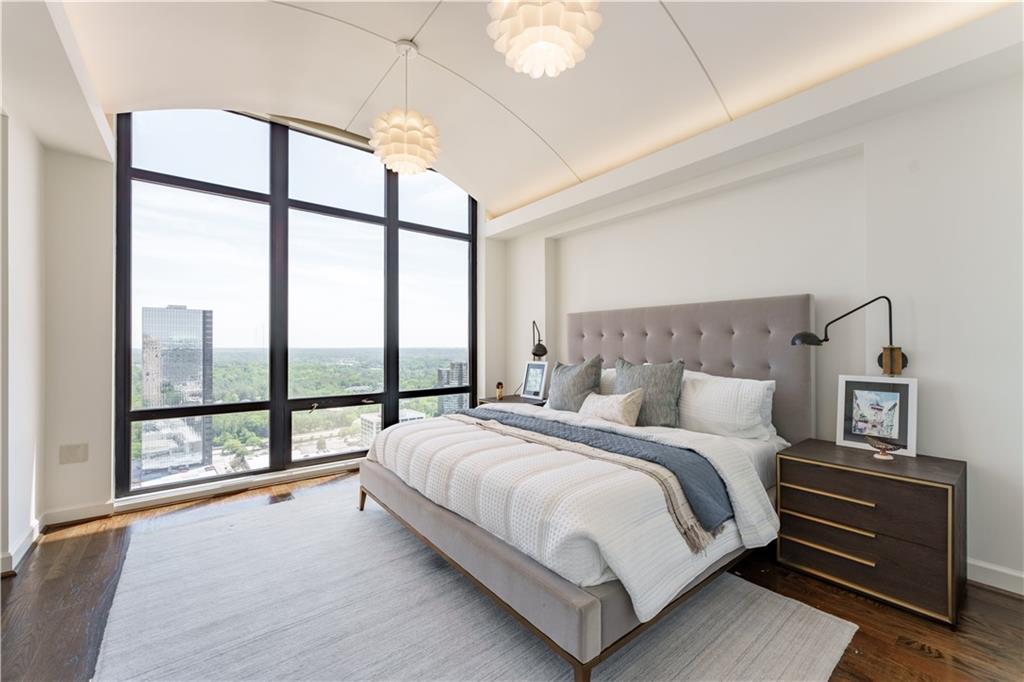 3475 Oak Valley Road Northeast, Unit 2940 Atlanta, GA 30326 - Photo 5 of 26 a bedroom with a large bed and a large window