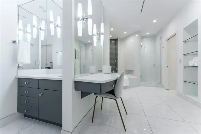 a bathroom with a sink a shower a mirror and a bathtub
