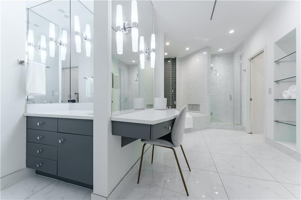 3475 Oak Valley Road Northeast, Unit 2940 Atlanta, GA 30326 - Photo 6 of 26 a bathroom with a sink a shower a mirror and a bathtub