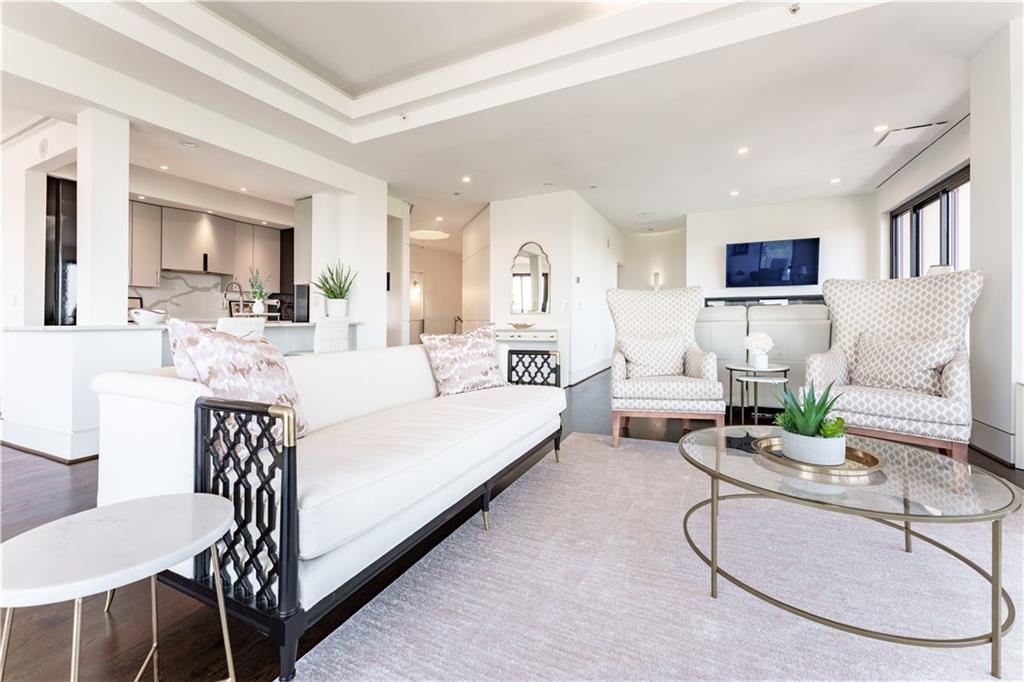 3475 Oak Valley Road Northeast, Unit 2940 Atlanta, GA 30326 - Photo 7 of 26 a living room with furniture a flat screen tv and a table