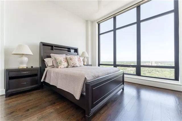 a bedroom with a bed and a large window