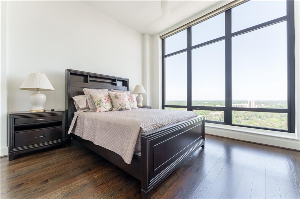 3475 Oak Valley Road Northeast, Unit 2940 Atlanta, GA 30326 - Photo 9 of 26 a bedroom with a bed and a large window
