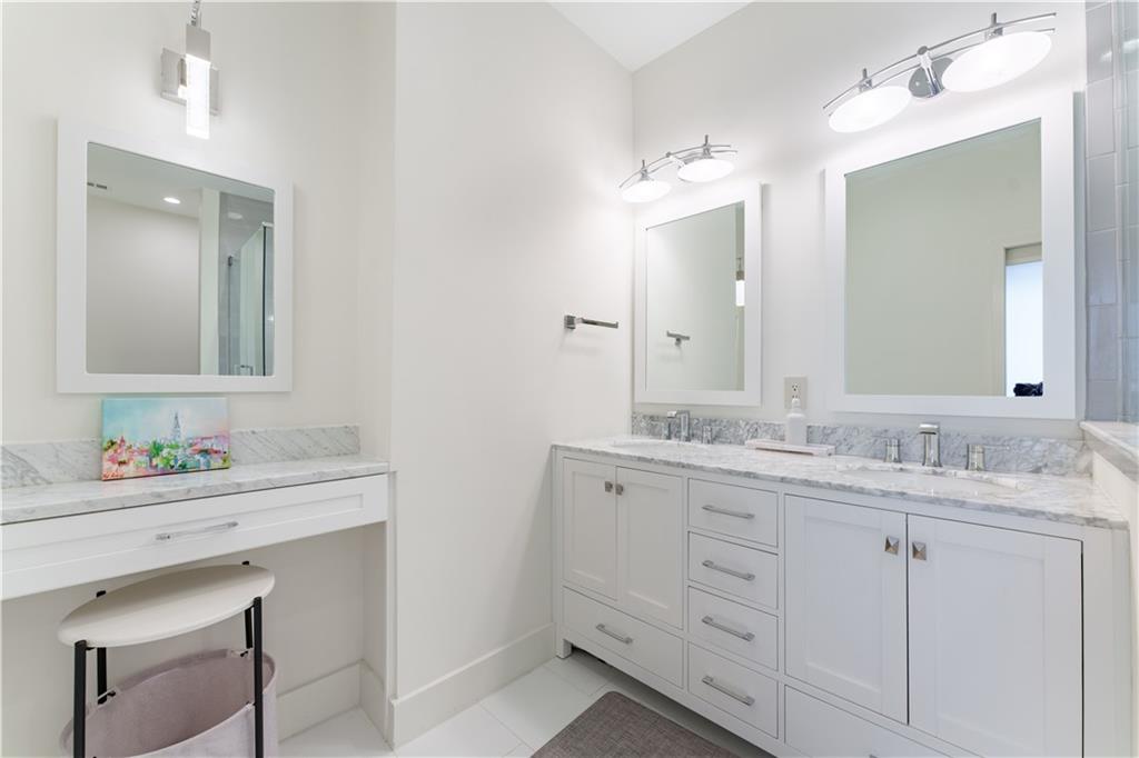 3475 Oak Valley Road Northeast, Unit 2940 Atlanta, GA 30326 - Photo 10 of 26 a bathroom with double sink and a mirror