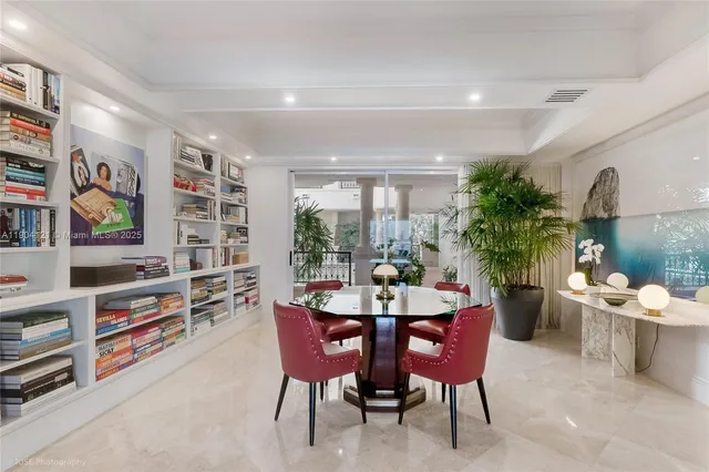a view of a dining room with furniture and a potted plant
