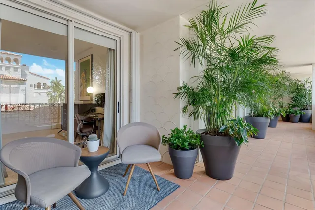 a view of a dining room with furniture and a potted plant
