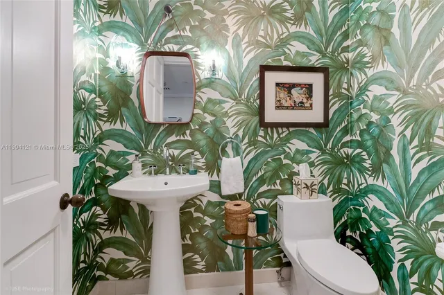 a bedroom with a bed and painting on the wall