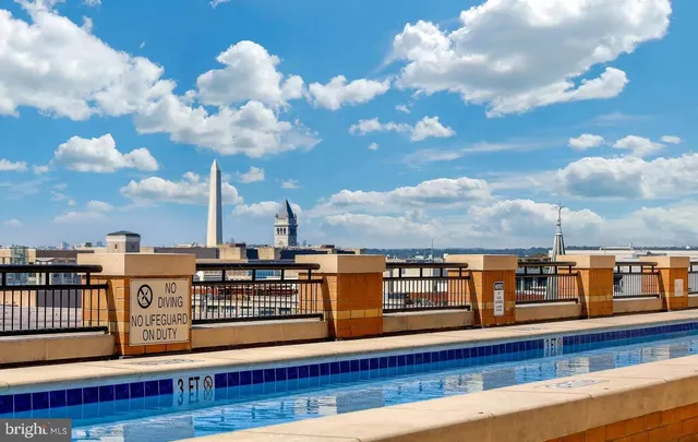 a view of a swimming pool with seating