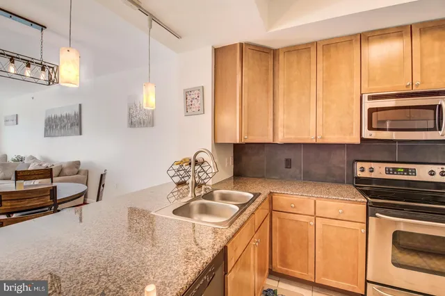 a kitchen with a stove a sink and a microwave