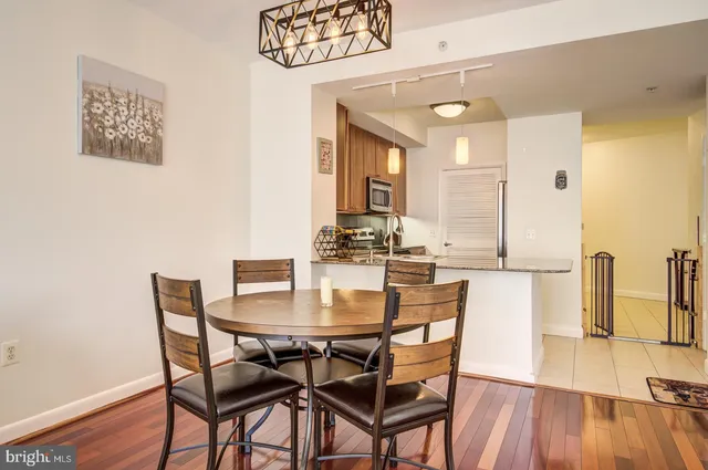 a view of a dining room with furniture and wooden floor