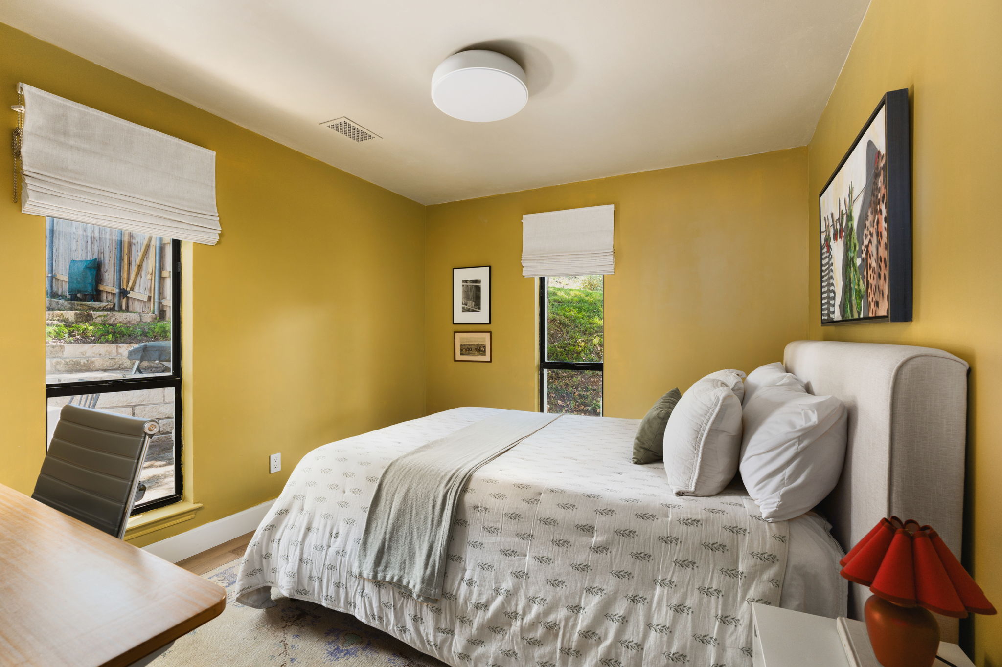 9101 Echo Point Cove Austin, TX 78759 - Photo 24 of 34 a bedroom with a bed and wooden floor