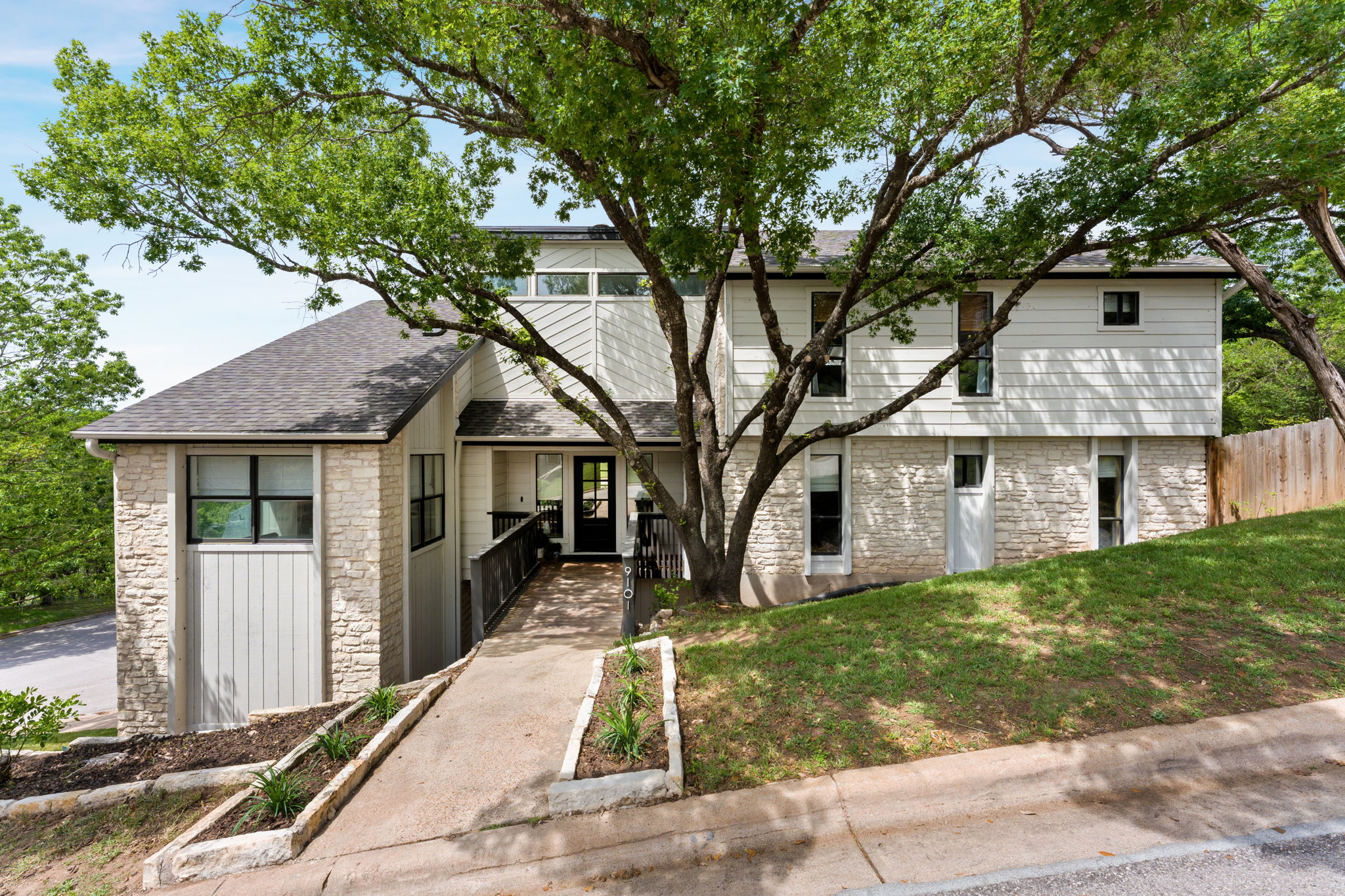 9101 Echo Point Cove Austin, TX 78759 - Photo 4 of 34 front view of a house with a yard