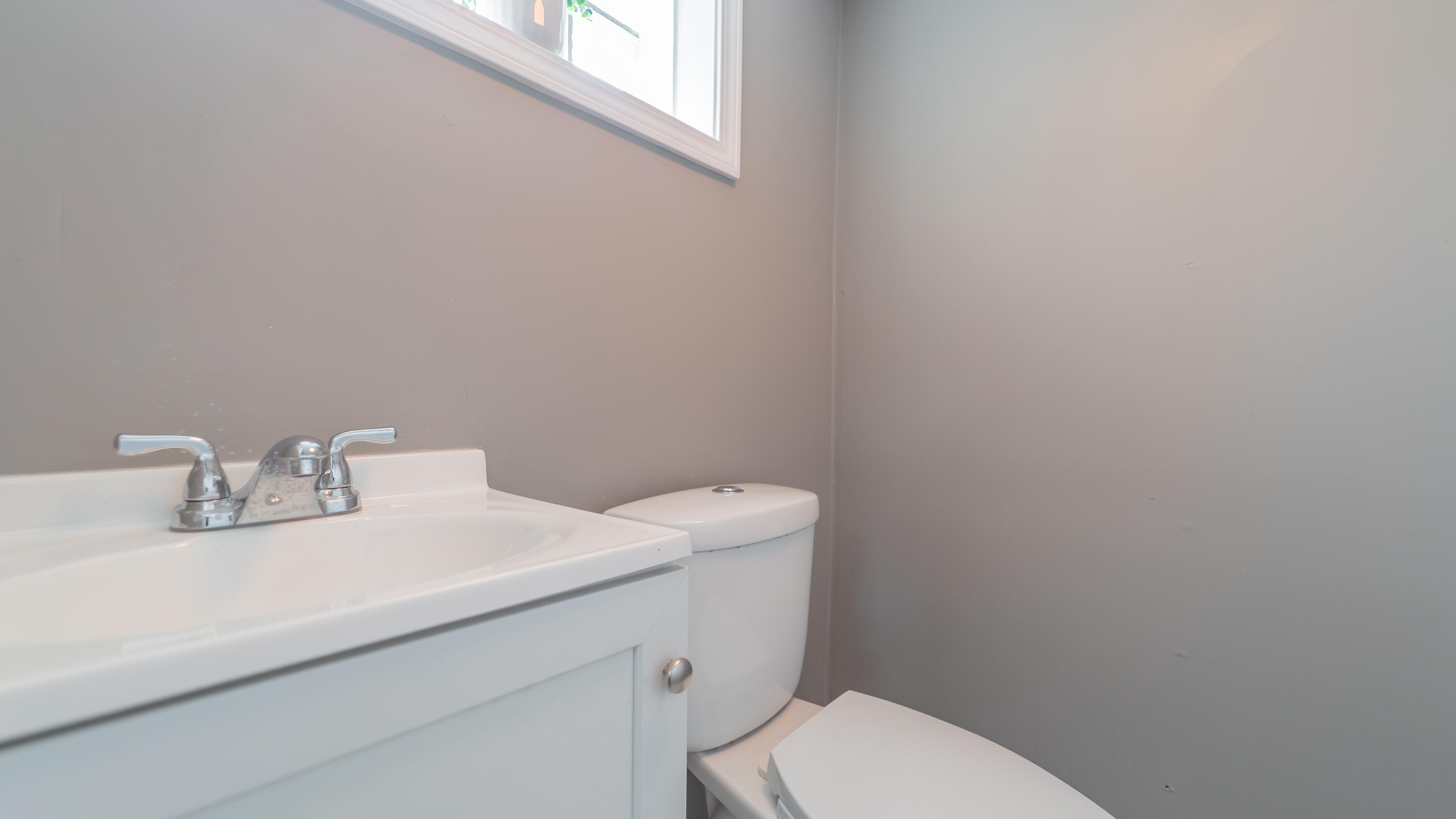 2257 West 16th Avenue Gary, IN 46404 - Photo 18 of 24 a bathroom with a sink a toilet and a mirror
