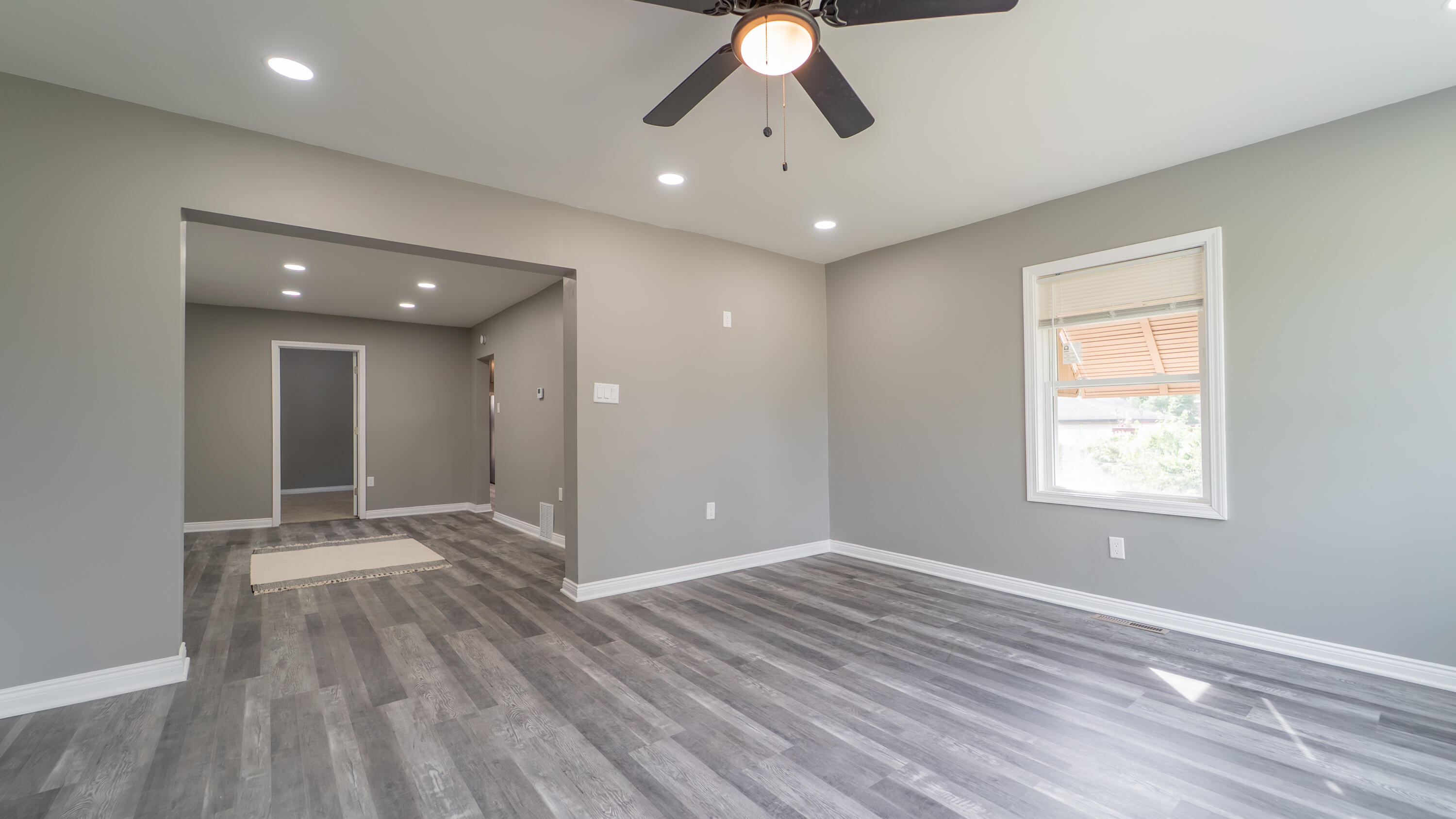 2257 West 16th Avenue Gary, IN 46404 - Photo 4 of 24 a view of an empty room with wooden floor and a window