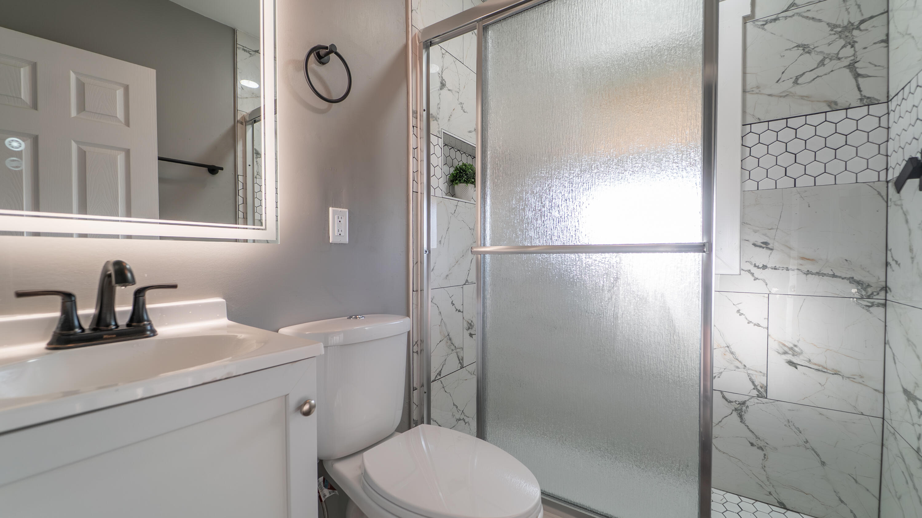 2257 West 16th Avenue Gary, IN 46404 - Photo 7 of 24 a bathroom with a sink a toilet and shower