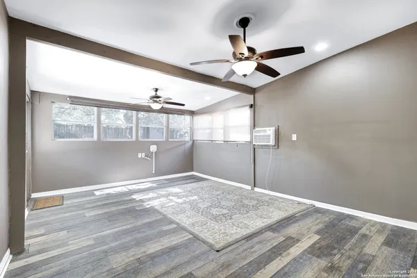 a view of a livingroom with a ceiling fan and window
