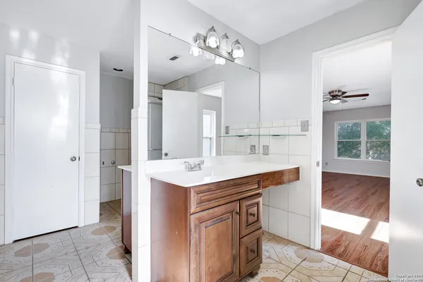 a view of kitchen with sink refrigerator and microwave