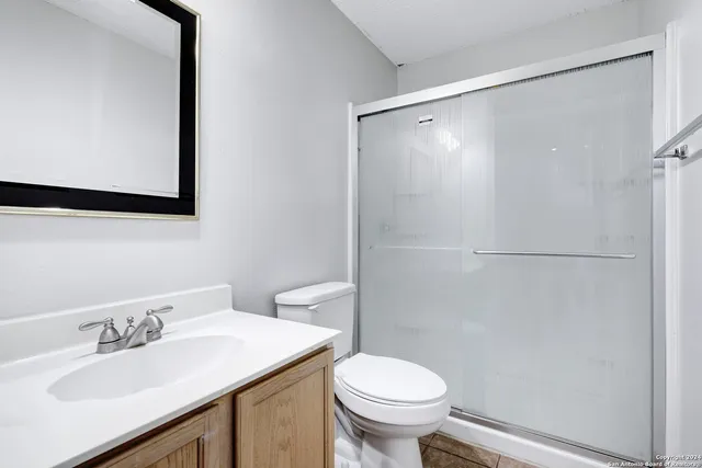 a bathroom with a sink toilet and shower
