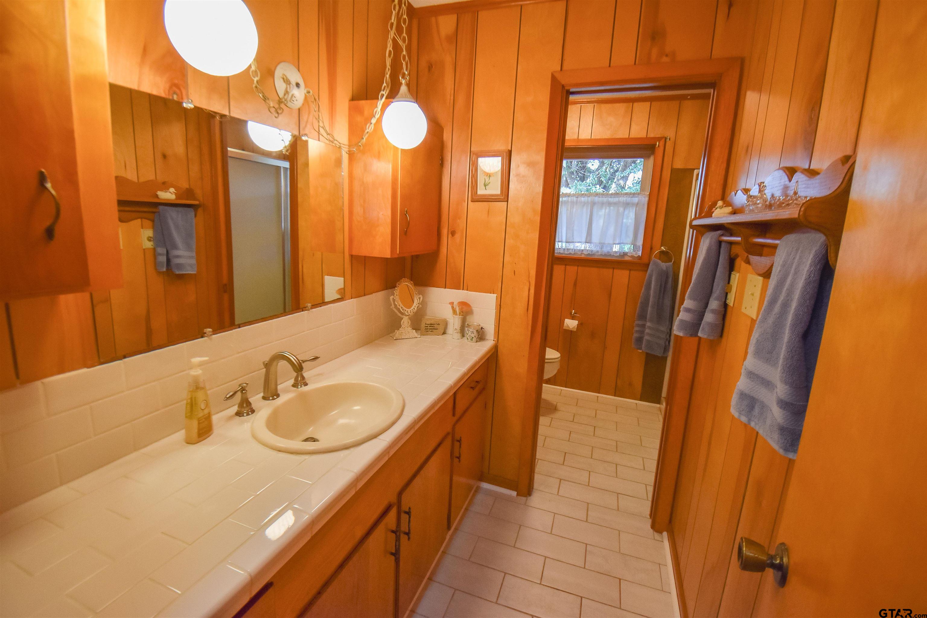 355 West Sugar Hill Road Reklaw, TX 75784 - Photo 27 of 38 a bathroom with a sink and a mirror