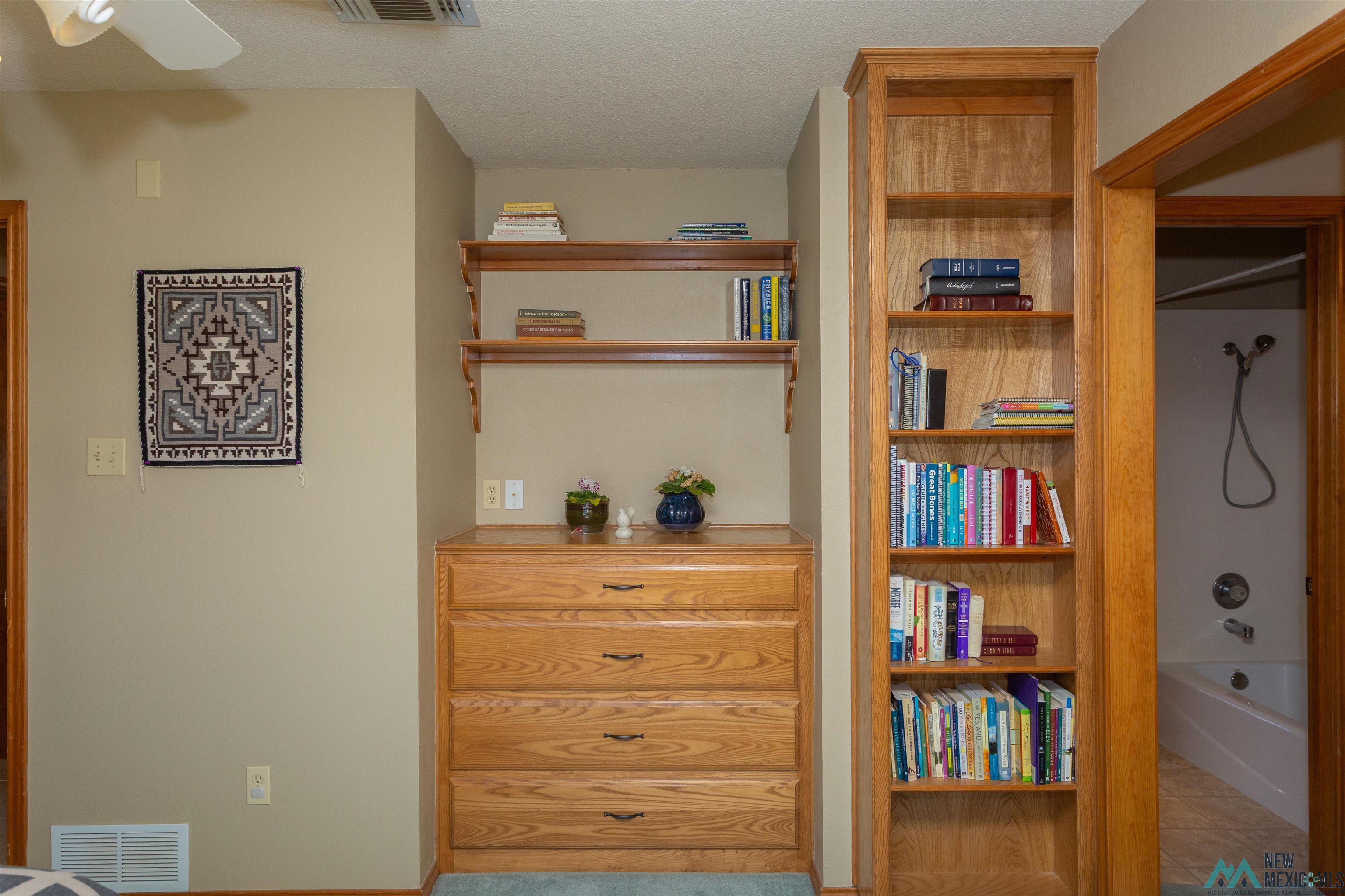 2012 South Haldeman Road Artesia, NM 88210 - Photo 27 of 96 Built-in oak cabinetry featuring a multi-drawer dresser, upper shelving, and a full-height bookcase