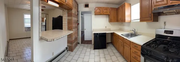a kitchen with a sink stove and refrigerator