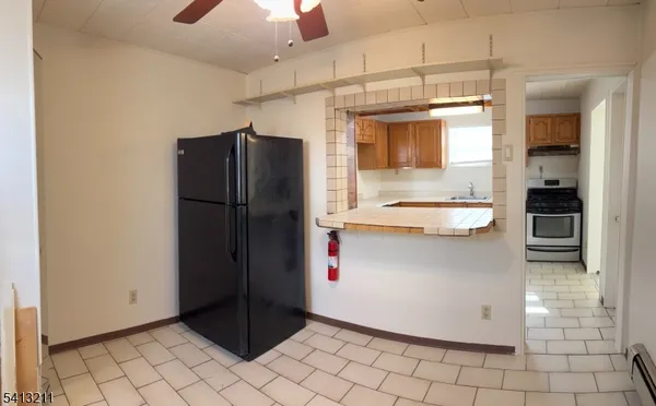 a kitchen with stainless steel appliances granite countertop a refrigerator and a stove