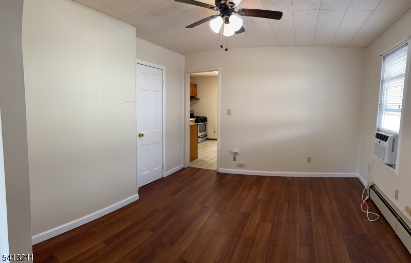4 Wall Street, Unit 2 Cranford, NJ 07016 - Photo 4 of 12 an empty room with wooden floor fan and windows