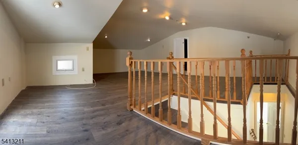 a view of entryway with stairs and wooden floor
