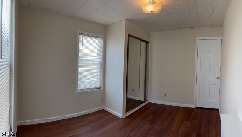4 Wall Street, Unit 2 Cranford, NJ 07016 - Photo 10 of 12 an empty room with wooden floor and windows