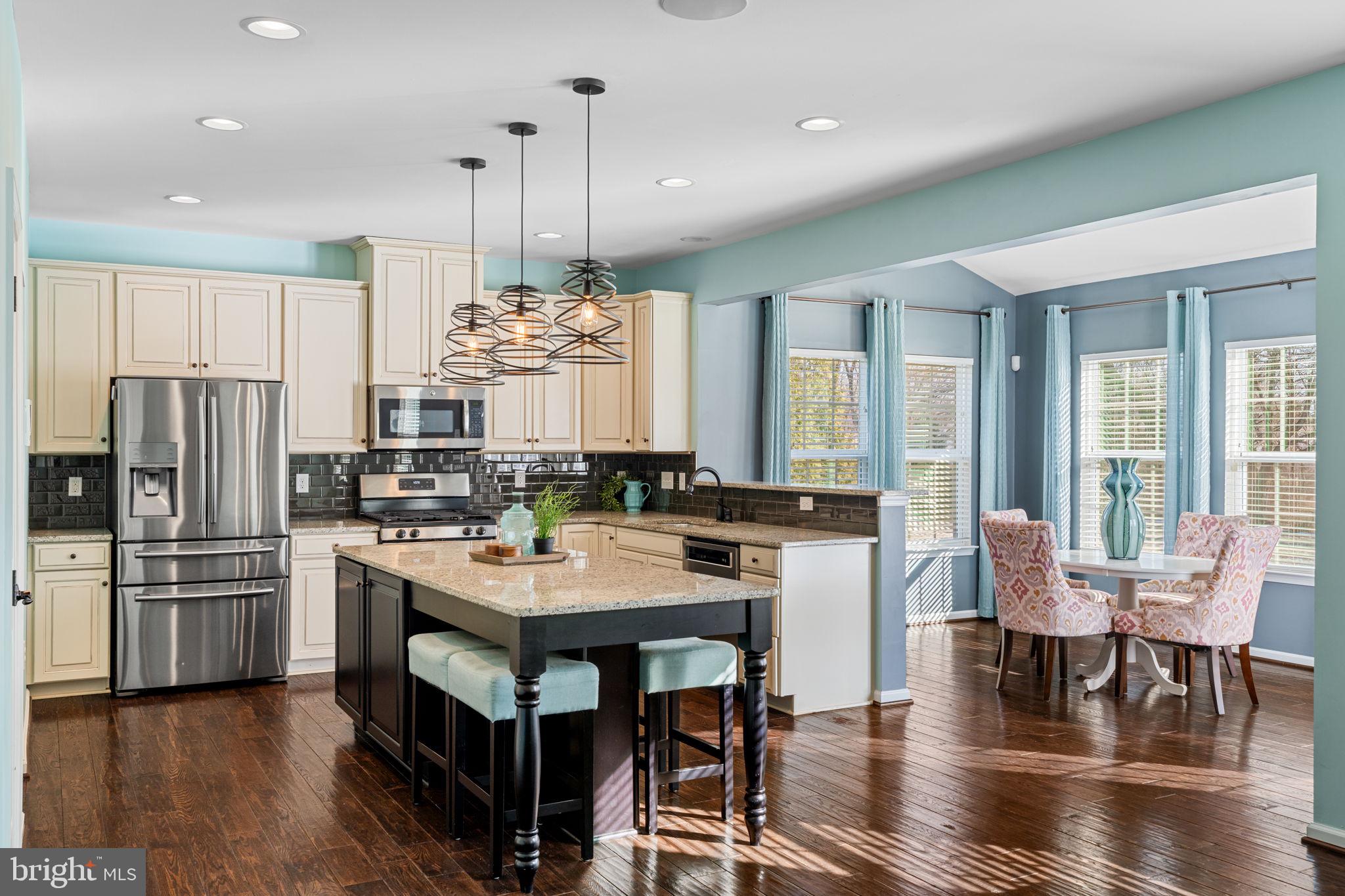 1145 Lynch Circle Warminster, PA 18974 - Photo 31 of 67 a kitchen with stainless steel appliances a dining table chairs stove and refrigerator