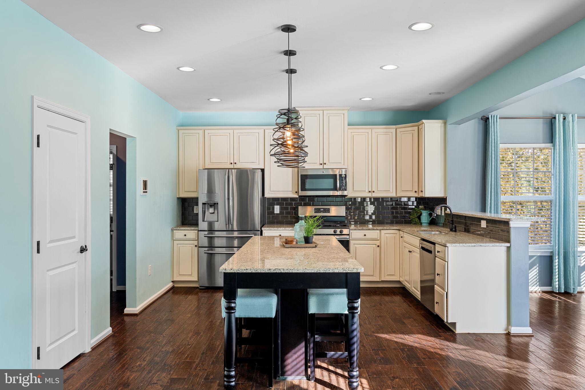 1145 Lynch Circle Warminster, PA 18974 - Photo 32 of 67 a kitchen with kitchen island a dining table chairs stainless steel appliances and cabinets