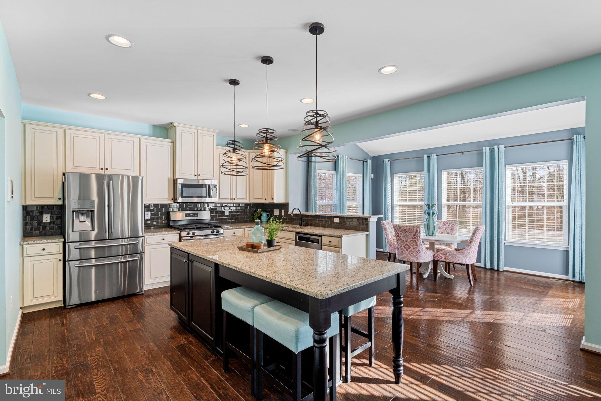 1145 Lynch Circle Warminster, PA 18974 - Photo 34 of 67 a kitchen with stainless steel appliances granite countertop a stove a refrigerator a kitchen island a sink cabinets and wooden floor