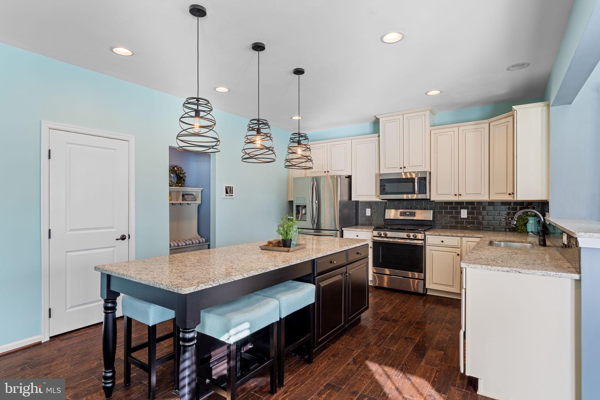 1145 Lynch Circle Warminster, PA 18974 - Photo 35 of 67 a large kitchen with kitchen island a stove a sink a refrigerator and a dining table