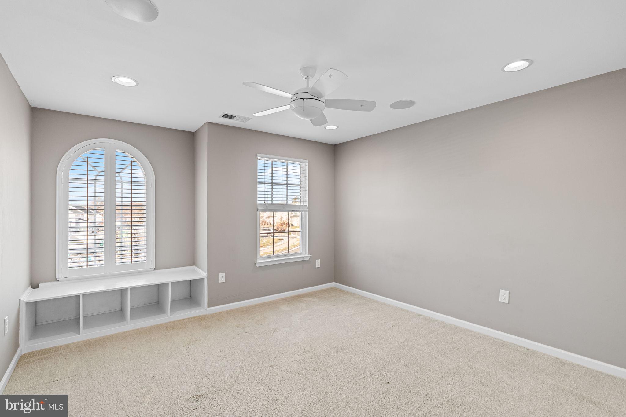 1145 Lynch Circle Warminster, PA 18974 - Photo 49 of 67 an empty room with windows and ceiling fan