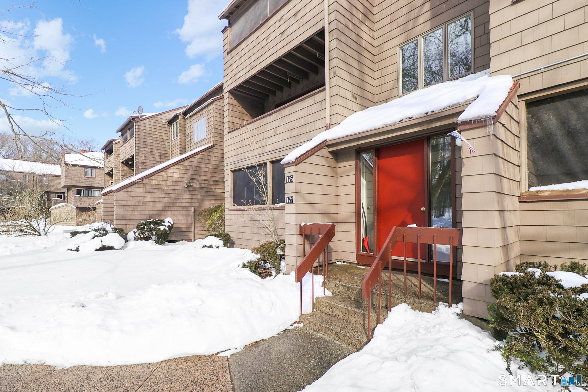 172 Towne House Road, Unit 172 Hamden, CT 06514 - Photo 3 of 20 a view of a patio with a table and chairs and ice snow