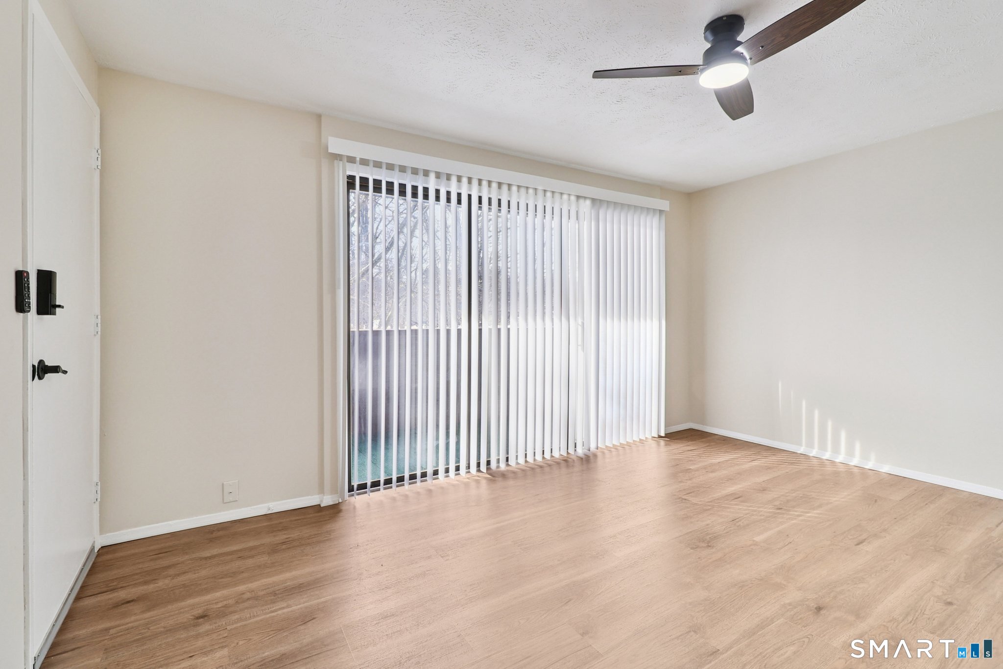 172 Towne House Road, Unit 172 Hamden, CT 06514 - Photo 6 of 20 wooden floor in an empty room with a window