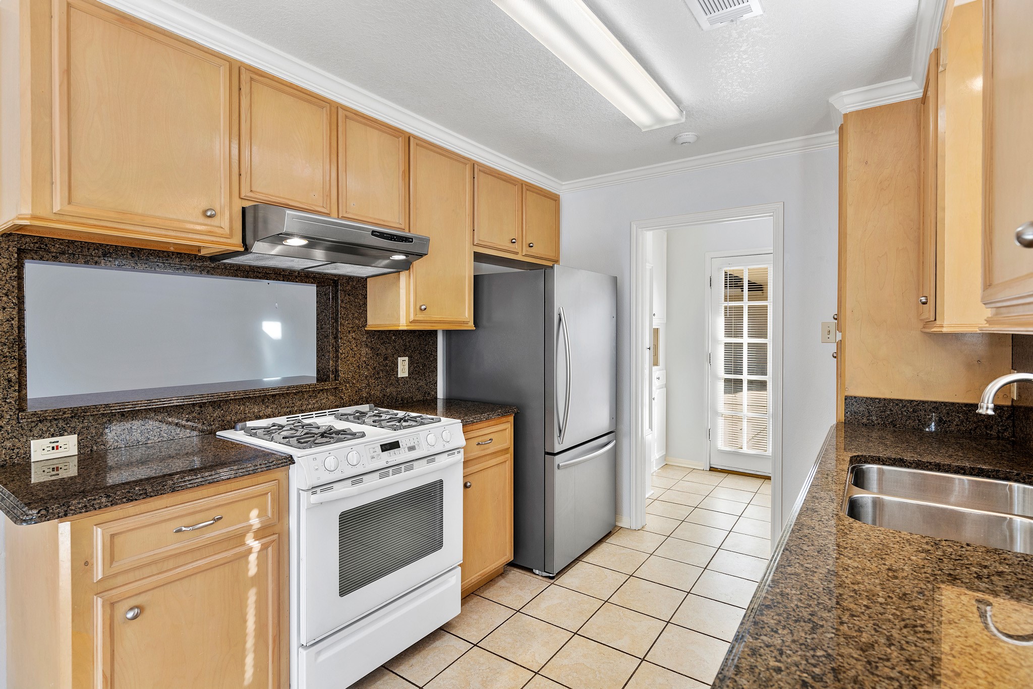 8018 Holiday Lane Houston, TX 77075 - Photo 20 of 42 a kitchen with stainless steel appliances granite countertop a stove a refrigerator and a cabinets